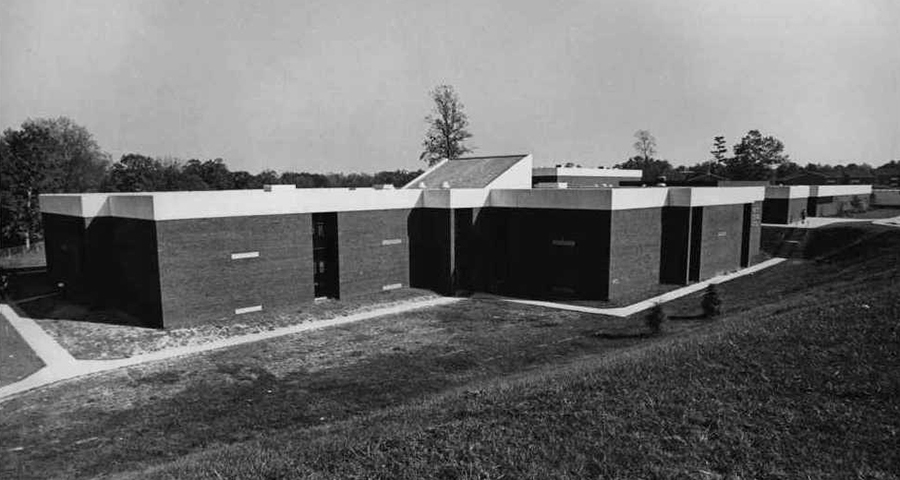 Black and white photograph of the completed Forest Edge Elementary School. The photograph is undated but was probably taken shortly after the building opened because of the trees planted in front of the school. These trees are not visible on aerial imagery after 1976.